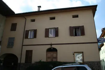 a building with windows and a car parked in front of it at Casa Basilio in Predazzo