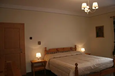 a bedroom with a bed and two lamps on tables at Casa Basilio in Predazzo