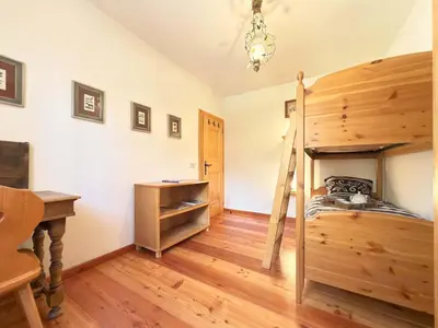 a bedroom with a bunk bed and a desk at Homeby, Dimora Sopiazes in Cortina dʼAmpezzo