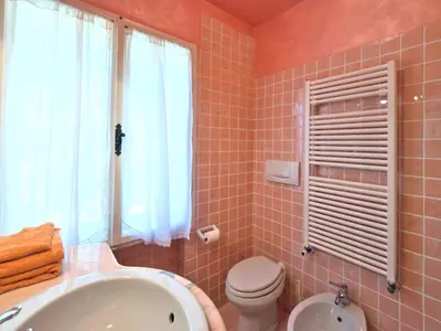 a bathroom with a tub and a toilet and a sink at Homeby, Dimora Sopiazes in Cortina dʼAmpezzo