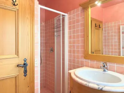 a bathroom with a sink and a shower with a mirror at Homeby, Dimora Sopiazes in Cortina dʼAmpezzo