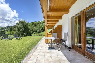 a patio with a table and chairs on a house at Residence Peter in Ortisei