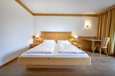 a bedroom with a large wooden bed in a room at Residence Peter in Ortisei