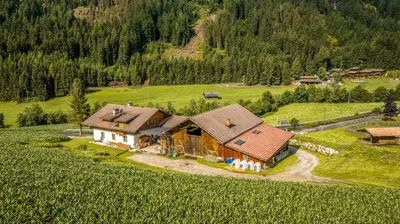 a bedroom with a bed with yellow and white sheets at Wieserhof Vals in Valles