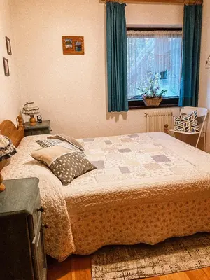 a bedroom with a bed and a window at Alloggio Il Cirmolo in Cavalese