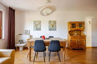 a kitchen with a table and chairs in a room at Casa dei Vessi il cuore di Fondo in Fondo