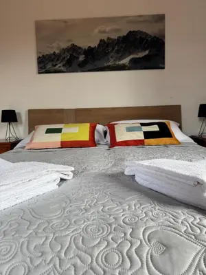 a bedroom with two beds with towels on them at Casa dei Vessi il cuore di Fondo in Fondo