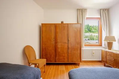 a bedroom with a wooden cabinet and a window at Casa dei Vessi il cuore di Fondo in Fondo