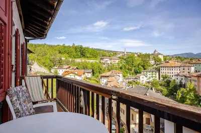 a balcony with a table and a view of a city at Casa dei Vessi il cuore di Fondo in Fondo