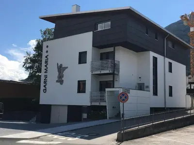 a black and white building with a sign on it at GARNI MARIA Appartement in Varna