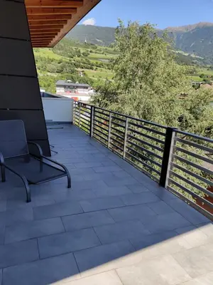 a balcony with a chair and a view at GARNI MARIA Appartement in Varna