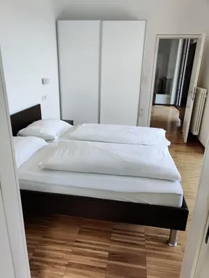 a large bed in a room with a mirror at GARNI MARIA Appartement in Varna