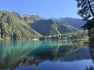 a view of a lake with mountains in the background at Aparthotel Carbonin in Dobbiaco