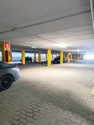 an empty parking garage with cars parked in it at Aparthotel Carbonin in Dobbiaco