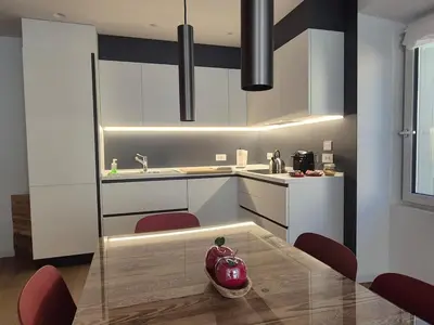 a kitchen with a red vase sitting on a table at RosAlpina in Cavalese