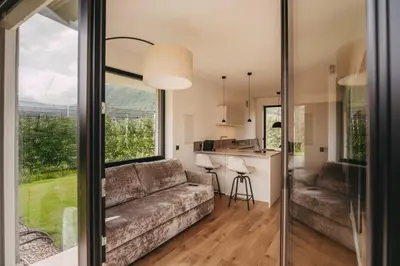 a living room with a couch and a kitchen at Luna apartments in Terlano