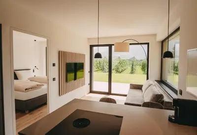 a living room with a couch and a bed at Luna apartments in Terlano