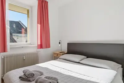 a bedroom with a bed with towels on it at City Center Penthouse Bolzano in Bolzano
