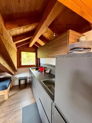a kitchen with wooden ceilings and a counter top at Pragma Apartments - Sky Lodge Bellamonte in Bellamonte