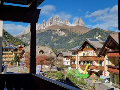 a view from a balcony of a town with mountains at Villa Erica in Alba di Canazei