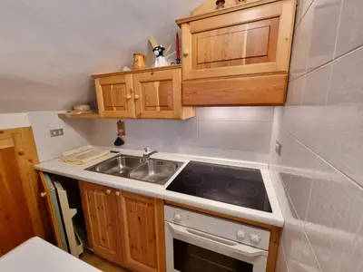 a kitchen with a sink and a stove at Villa Erica in Alba di Canazei