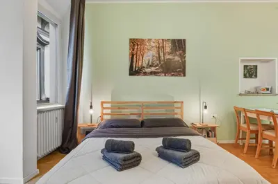a bedroom with a large bed with two blue cushions at Lauben Apartment II Bolzano in Bolzano