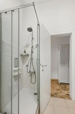 a shower with a glass door in a bathroom at Lauben Apartment II Bolzano in Bolzano
