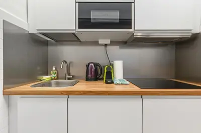 a kitchen counter with a sink and a microwave at Lauben Apartment II Bolzano in Bolzano