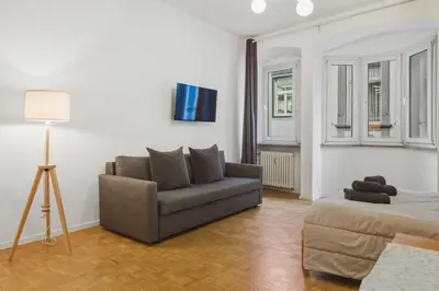 a living room with a couch and a bed at Lauben Apartment II Bolzano in Bolzano