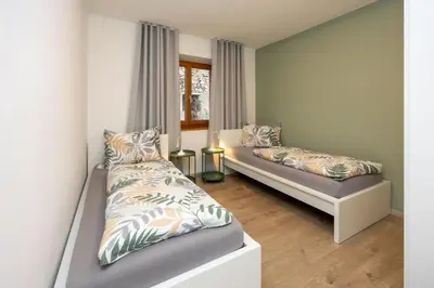 a bedroom with two beds and a window at Ferienhaus Karin in Cortaccia
