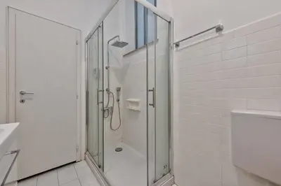 a bathroom with a shower with a glass door at Lauben Balcony Bolzano in Bolzano