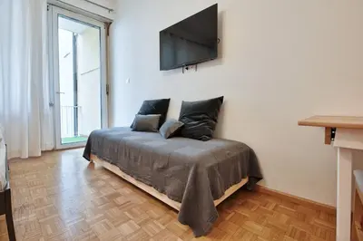 a bedroom with a bed with a flat screen tv on the wall at Lauben Balcony Bolzano in Bolzano