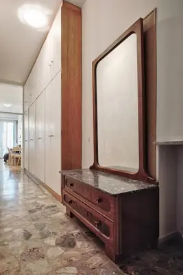 a dressing room with a large mirror on a dresser at Lauben Balcony Bolzano in Bolzano