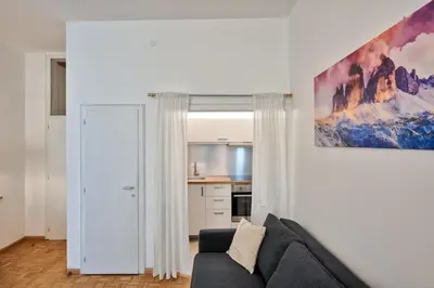 a living room with a couch and a painting on the wall at Lauben Balcony Bolzano in Bolzano