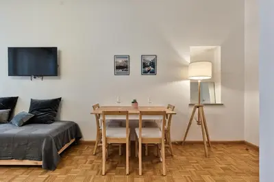 a bedroom with a table and a bed and a television at Lauben Balcony Bolzano in Bolzano