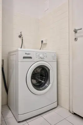 a washing machine in a corner of a room at Lauben Balcony Bolzano in Bolzano