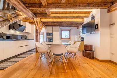 a kitchen and dining room with a table and chairs at Un Sogno Tra Le Dolomiti in Frena
