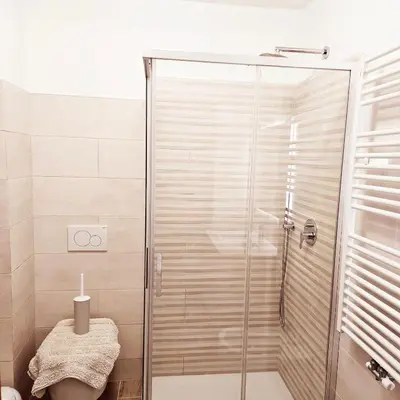 a shower with a glass door in a bathroom at Cesira in Mareson
