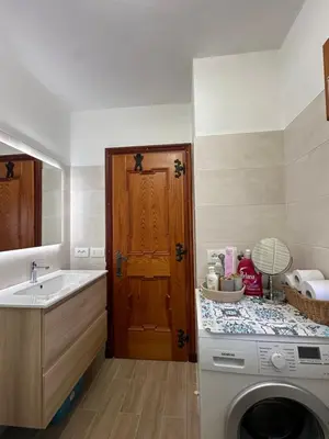 a kitchen with a washing machine and a sink at Cesira in Mareson