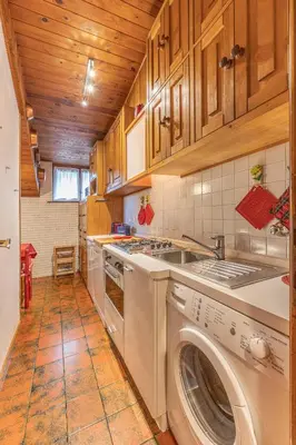 a kitchen with a washer and dryer in it at Casa Fior di Ghiaccio in Cortina dʼAmpezzo