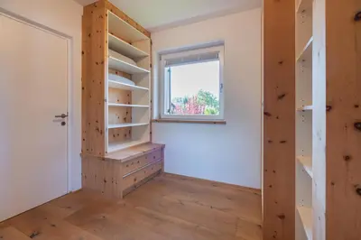 a room with wooden shelves and a window at Sweethome Apple in Fiumes