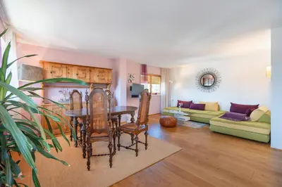 a living room with a table and a couch at Sweethome Apple in Fiumes