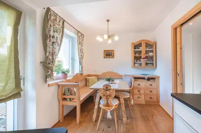 a kitchen with a table and chairs and a dining room at Sweethome Apple in Fiumes