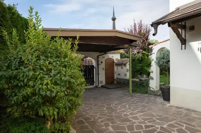 a house with a courtyard with a church at Sweethome Apple in Fiumes