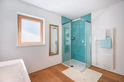 a bathroom with a shower with a glass shower stall at Sweethome Apple in Fiumes