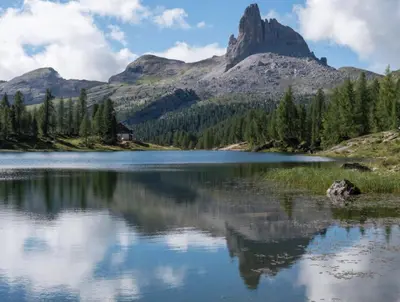 a mountain reflection in a lake in the mountains at Appartamenti Chantal in San Martino in Badia