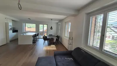 a living room with a couch and a table with chairs at Oase mit Fernblick in Mühlbach