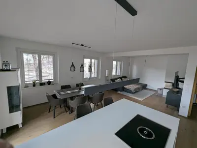 a kitchen and living room with a table and chairs at Oase mit Fernblick in Mühlbach