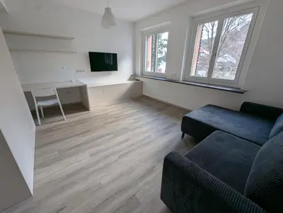 a living room with a couch and a tv at Oase mit Fernblick in Mühlbach