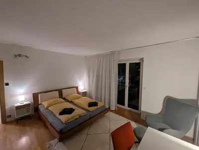 a bedroom with a bed and a couch and a chair at Oase mit Fernblick in Mühlbach